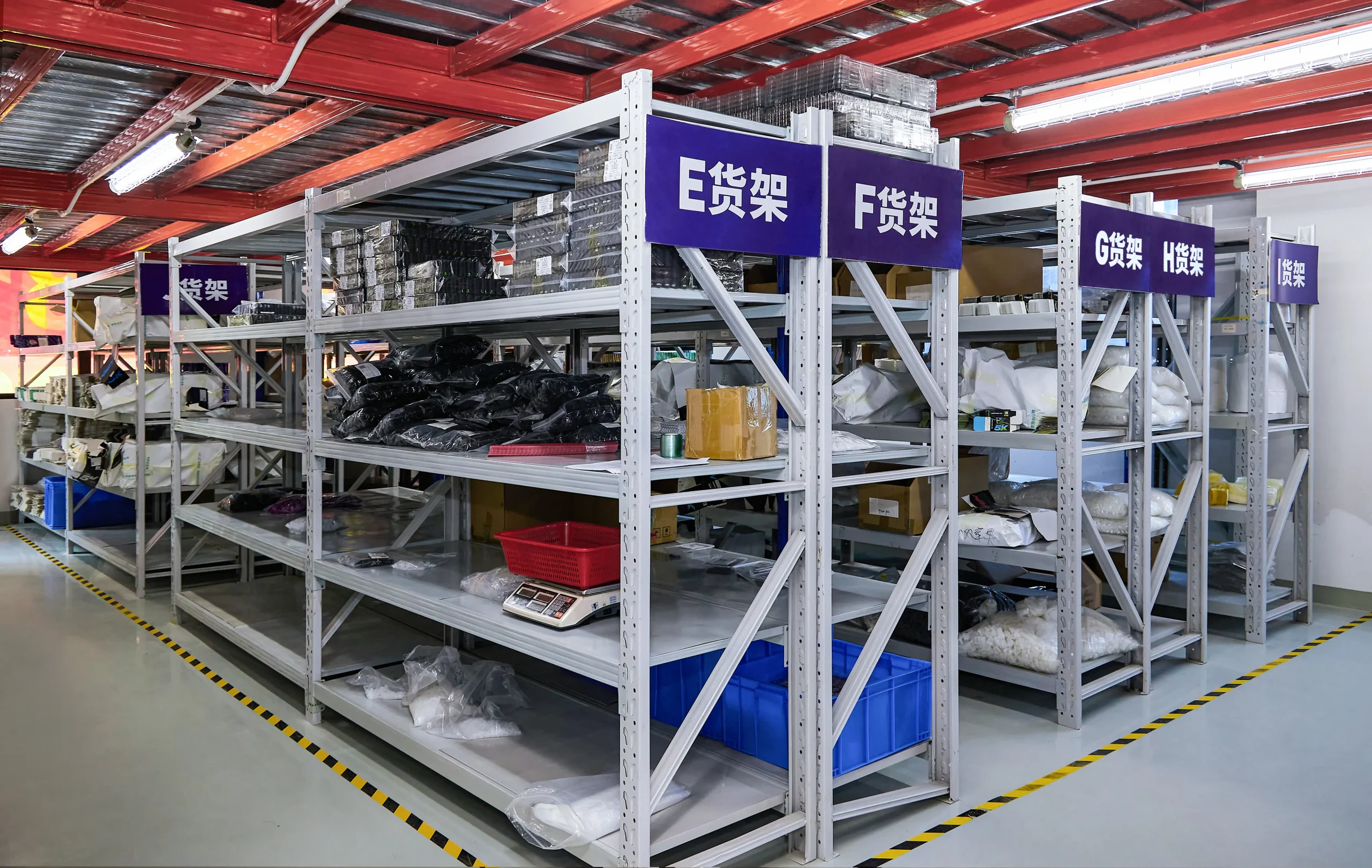 Labeled metal component storage shelving racks in Vape ODM Factory's organized warehouse for vape parts and materials