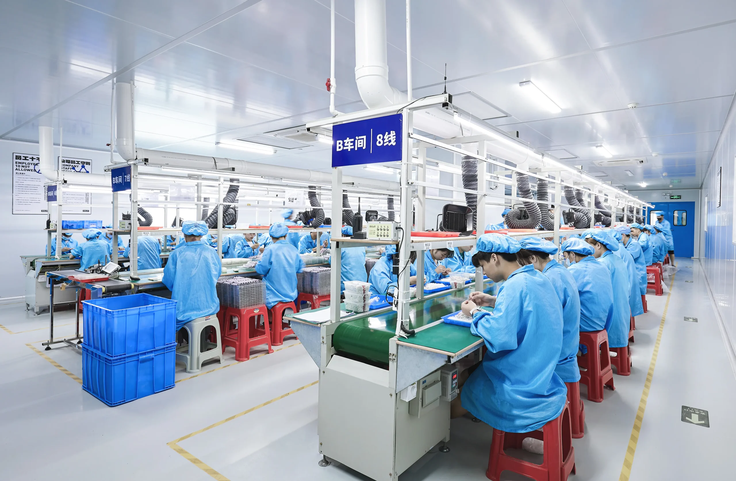 Workers in blue cleanroom uniforms assembling disposable vape devices on active production line 8 in Workshop B at Vape ODM Factory